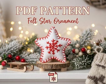 Puede incluir: Un adorno de estrella de fieltro blanco con detalles de copos de nieve bordados en rojo y puntada de festón roja en los bordes. El texto PDF PATTERN Felt Star Ornament aparece arriba, con un pequeño icono de PDF debajo.