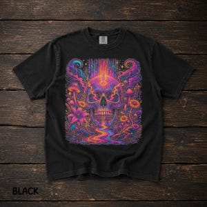 May include: A black short-sleeve t-shirt featuring a vibrant, multicolored graphic print of a human skull surrounded by stylized mushrooms, flowers, and swirling cosmic patterns with a flowing liquid stream emanating from the base.