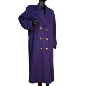 May include: A long, deep purple double-breasted coat featuring a wide notched lapel collar, long sleeves, and six gold-toned circular buttons arranged in two vertical rows down the front. The coat has two side pockets and a structured shoulder design.