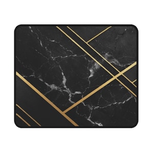 May include: A rectangular mouse pad featuring a black marble pattern with white veining. The surface is accented by thin, straight gold lines that intersect diagonally across the dark stone texture, finished with a solid black stitched border.