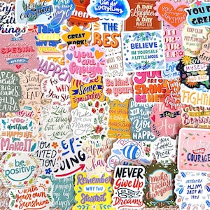 May include: A collection of colorful vinyl stickers featuring various motivational quotes and phrases such as You are enough, Believe in yourself, Never give up on your dreams, and Make your own magic, displayed in diverse fonts and decorative styles.