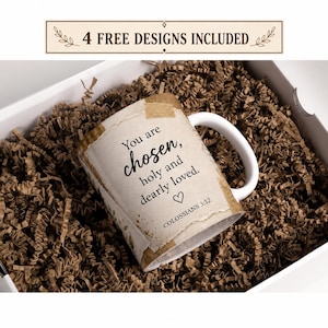 May include: A white ceramic mug featuring a beige, paper-like wrap with the text "You are chosen, holy and dearly loved." and "COLOSSIANS 3:12" printed in black, accompanied by a small heart icon. The mug is nestled in a box filled with brown paper shreds.