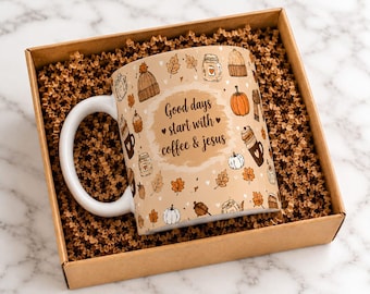 May include: A white ceramic mug featuring a tan background with a repeating pattern of autumn-themed illustrations including pumpkins, leaves, beanies, and jars. The center text reads Good days start with coffee & jesus in dark brown lettering.