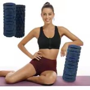 May include: A dark blue foam roller with a textured surface featuring multiple rectangular indentations. The cylindrical fitness tool is designed for muscle recovery and massage, shown in a solid dark blue color with a firm, molded foam construction.