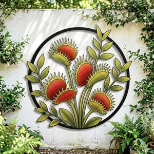 May include: A circular metal wall art piece featuring a stylised illustration of several Venus flytrap plants. The plants have vibrant red interiors with green, spiky-edged traps and green stems and leaves, all enclosed within a thin black circular frame.