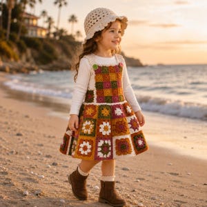 May include: A child wearing a long-sleeved white shirt under a sleeveless crochet dress featuring a multicolored granny square pattern in shades of mustard, olive, burgundy, and white, paired with a matching cream crochet bucket hat and brown boots.