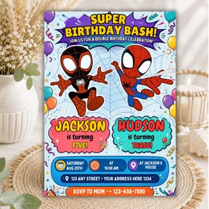 May include: A rectangular birthday invitation card featuring two cartoon superheroes in red and black suits against a light blue spiderweb background. Text includes SUPER BIRTHDAY BASH, JACKSON is turning FIVE, HUDSON is turning THREE, and event details.