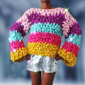 May include: A colorful striped crochet sweater with long sleeves and a loose fit.