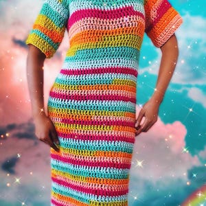 May include: A colorful striped crochet dress with short sleeves. The dress is made with a variety of bright colors, including pink, orange, yellow, green, and blue.