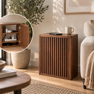 May include: A rectangular wooden cabinet with a slatted front door and a smooth top surface. The interior features two shelves designed for cable management, housing a power strip with multiple plugged-in cords and various electronic adapters.