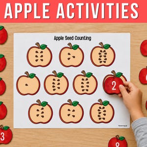 May include: An educational Apple Activities worksheet titled Apple Seed Counting featuring illustrations of halved apples with varying seed counts. Ten red apple cutouts numbered one through ten are arranged around the central white sheet.