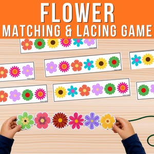 May include: A flower matching and lacing game featuring multiple rectangular cards with colorful flower illustrations and a set of individual flower-shaped cutouts with holes for threading onto a green string, displayed on a light wood surface.