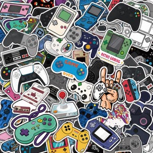 Op de afbeelding: Een verzameling diverse vinylstickers met verschillende retro en moderne videogameconsoles, handheld-apparaten en controllers in diverse kleuren, waaronder een blauwe controller met de tekst Game Over en een groene met Retro Gaming.