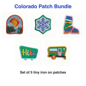 May include: A Colorado Patch Bundle featuring five iron-on patches: a mountain landscape with a sun, a blue snowflake, a green ski boot, a green sign with the text Hike, and a green camper trailer with yellow and orange accents.