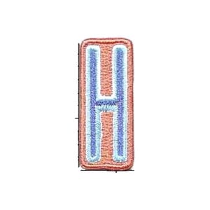 May include: A rectangular embroidered patch featuring the letter H in a light blue thread color, outlined in a darker blue, set against a peach-colored background with a thick, rounded, and textured peach-colored border.