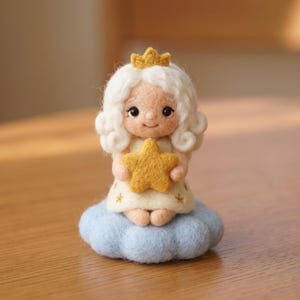 May include: A needle felted figurine of a small character with curly white hair and a gold crown, wearing a cream-coloured dress with small star patterns. The character holds a yellow star and sits atop a textured, light blue felted cloud base.