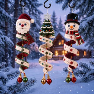 May include: Three hanging crochet ornaments featuring a Santa Claus, a Christmas tree, and a snowman. Each figure is attached to a long, spiraling cream-coloured ribbon decorated with red and green embroidered snowflakes and small colourful beads.