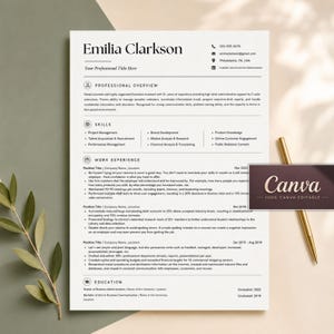 May include: A professional resume template for Emilia Clarkson featuring black text on a white background with sections for professional overview, skills, work experience, and education. A gold pen rests beside the document, which includes a Canva logo.