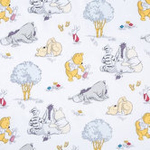May include: A white fabric featuring a repeating pattern of Winnie the Pooh and his friends, including Piglet, Tigger, and Eeyore. The characters are depicted in a cartoon style and are surrounded by trees, flowers, and other woodland elements.