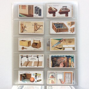 May include: A set of vintage Wills Cigarettes trading cards, showing detailed illustrations of carpentry and woodworking tools and techniques. The cards are displayed in a clear plastic sheet.