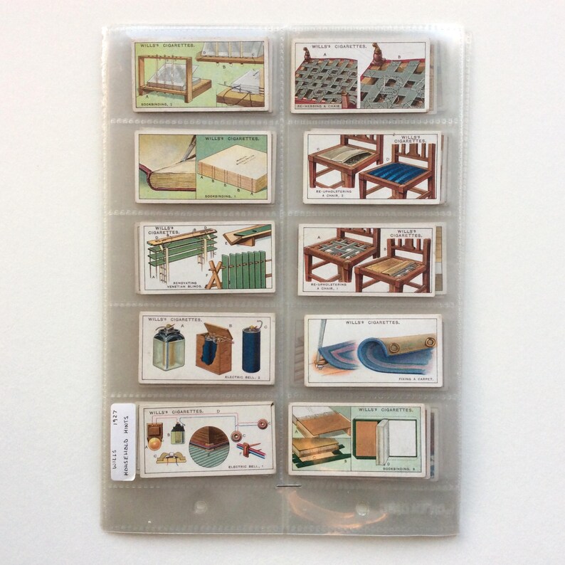 May include: A collection of vintage Wills's Cigarettes cards, illustrating various objects and processes. The cards are displayed in a clear plastic holder, showcasing their detailed artwork and historical context. The cards are from 1927.