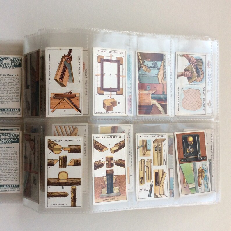 May include: A selection of vintage Wills's Cigarettes cards, held in a clear plastic display. The cards depict illustrations of carpentry tools and methods, with text including "Rustic Work" and "Broken Line".