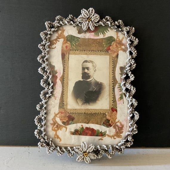 An antique Sicilian beaded picture frame — genuinely traditional craft technique from a specific cultural tradition, not something you stumble across every day.