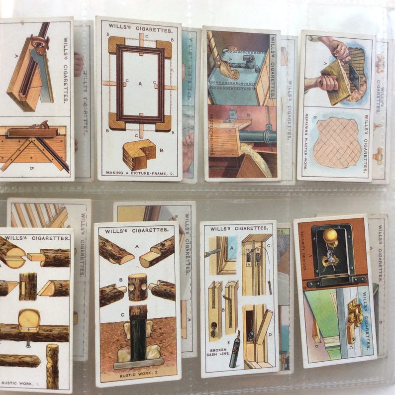May include: A set of vintage Wills's Cigarettes cards, showcasing illustrations related to carpentry and woodworking. The cards display different stages of construction, such as making picture frames and rustic work. The text "WILLS'S CIGARETTES" is printed on each card.