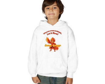 Puede incluir: Una sudadera con capucha blanca que presenta un gráfico de una criatura naranja y roja ardiente. El texto sobre la criatura dice "What you create is MAGIC. Let it flow!" y el texto debajo dice "Sacral Energy" en naranja.