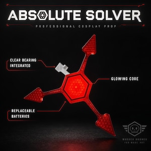 May include: A red, three-pointed Absolute Solver cosplay prop with a hexagonal center. Text labels indicate a clear bearing, a glowing core, and replaceable batteries. The top text reads ABSOLUTE SOLVER PROFESSIONAL COSPLAY PROP.