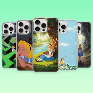 May include: Five clear phone cases featuring various illustrations of a blonde character in a blue dress. Designs include a green hedge maze, a close-up portrait, a character reading under a tree, a blue sky with daisies, and a forest path scene.