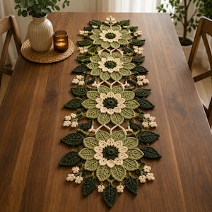 May include: A long, rectangular crochet table runner featuring a repeating floral pattern in shades of dark green, sage green, and cream. The design consists of four large, multi-layered flower motifs connected by intricate lace-like crochet work.