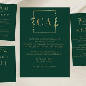 May include: A set of dark green wedding stationery featuring gold text and a gold frame monogram with the letters CA. The set includes a wedding invitation, an RSVP card, a menu card, and a table number card, all with matching gold floral accents.