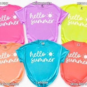 May include: Six vibrant t-shirts in neon shades of pink, violet, lemon, cantaloupe, lagoon, and red-orange. Each shirt features the white text "hello summer" and a sun graphic. The shirts are a summery fashion item.