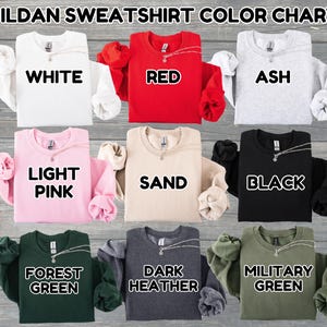 May include: A color chart displaying Gildan sweatshirts in various colors. The colors include white, red, ash, light pink, sand, black, forest green, dark heather, and military green. Each sweatshirt has a necklace.