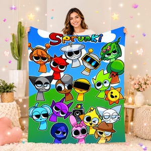 May include: A soft fleece blanket featuring a vibrant, colorful graphic print of various cartoon characters from Sprunki against a blue sky and green hill background. The word Sprunki is printed in large, bold, multi-colored letters at the top.