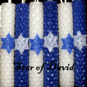 May include: A set of six blue and white honeycomb candles with a Star of David design. The candles are arranged in a row and have a textured surface.