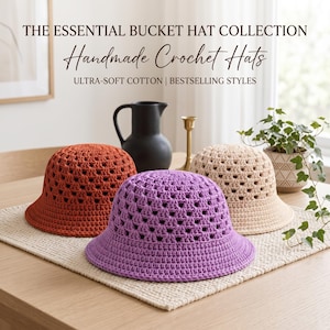 May include: Three handmade crochet bucket hats in rust orange, lavender, and cream. The text reads: THE ESSENTIAL BUCKET HAT COLLECTION, Handmade Crochet Hats, ULTRA-SOFT COTTON | BESTSELLING STYLES. Each hat features a repeating open-work pattern.