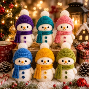May include: Six crocheted snowman figurines, each wearing a matching knit hat with a white pom-pom and a scarf. The snowmen have white bodies, orange carrot-shaped noses, black eyes, and two buttons on their chests in purple, teal, pink, blue, yellow, and green.