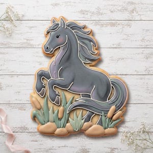 May include: A horse-shaped sugar biscuit decorated with grey icing, featuring a rearing horse with a flowing mane and tail. The base of the biscuit depicts green reeds, tan cattails, and smooth beige stones, all outlined in white icing.