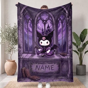 May include: A purple fleece blanket featuring a cartoon character with black ears and a skull emblem, sitting in a gothic stone archway with gargoyles. The background shows a castle silhouette under a crescent moon. The word NAME is printed below.