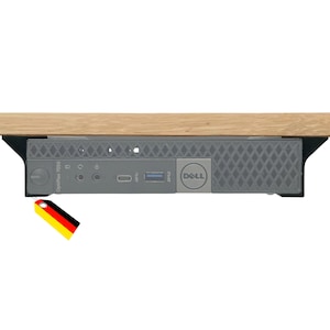 Könnte beinhalten: Ein Dell OptiPlex 7050 Mikro-Computer, der unter einer Holzoberfläche montiert ist. Die Vorderseite zeigt einen Ein-/Ausschalter, Kopfhörer- und Mikrofonanschlüsse, einen USB-C-Port, einen USB-A-Port und das Dell-Logo. Ein kleines Etikett mit schwarz-rot-goldenen Streifen hängt an der Ecke.
