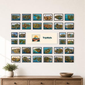 May include: A gallery wall arrangement featuring numerous small rectangular framed prints of various US states, each displaying a colorful illustrated map. A central horizontal rectangular sign displays the text TripWalls.