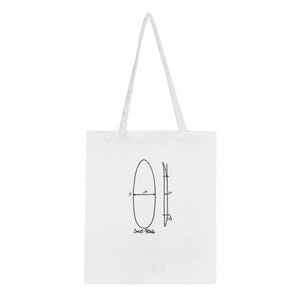 May include: A white tote bag featuring a black line drawing of a surfboard with dimensions labeled 5'8" and 22 1/4" on the front. Below the surfboard illustration, the text "Sweet Potato" is printed in a handwritten black font style.