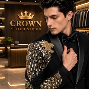 May include: A black tuxedo jacket featuring a prominent gold and white embroidered lion head on the shoulder, with intricate gold and white feather-like embroidery extending down the sleeve, paired with a black shirt and a black satin bow tie.