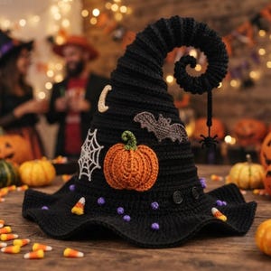 May include: A black crocheted witch hat with a curled tip featuring a dangling spider. The hat is decorated with a crocheted orange pumpkin, a white spiderweb, a grey bat, a crescent moon, small purple beads, and candy corn accents.