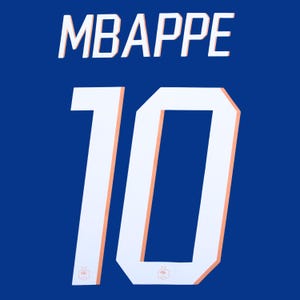 May include: A royal blue sports jersey featuring the name MBAPPE in white block lettering above the large number 10. The number 10 is rendered in white with a thin light orange outline and includes a small emblem at the base of each digit.