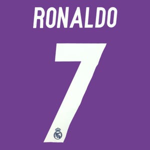 May include: A purple sports jersey featuring the name RONALDO in white capital letters above a large white number 7. The number 7 includes a small, dark blue Real Madrid club crest logo at the bottom, printed directly onto the fabric surface.