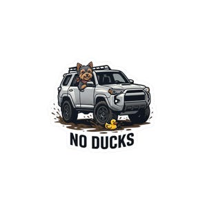May include: A sticker featuring a silver off-road vehicle driving through mud with a small brown dog leaning out of the driver side window. A yellow rubber duck sits in the mud in front of the vehicle. The text NO DUCKS is printed in black below.