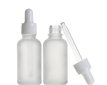 May include: Two frosted glass dropper bottles with white rubber-topped glass droppers. One bottle is fully assembled with the dropper inserted, while the other bottle is open with the glass pipette removed and positioned to the right side.
